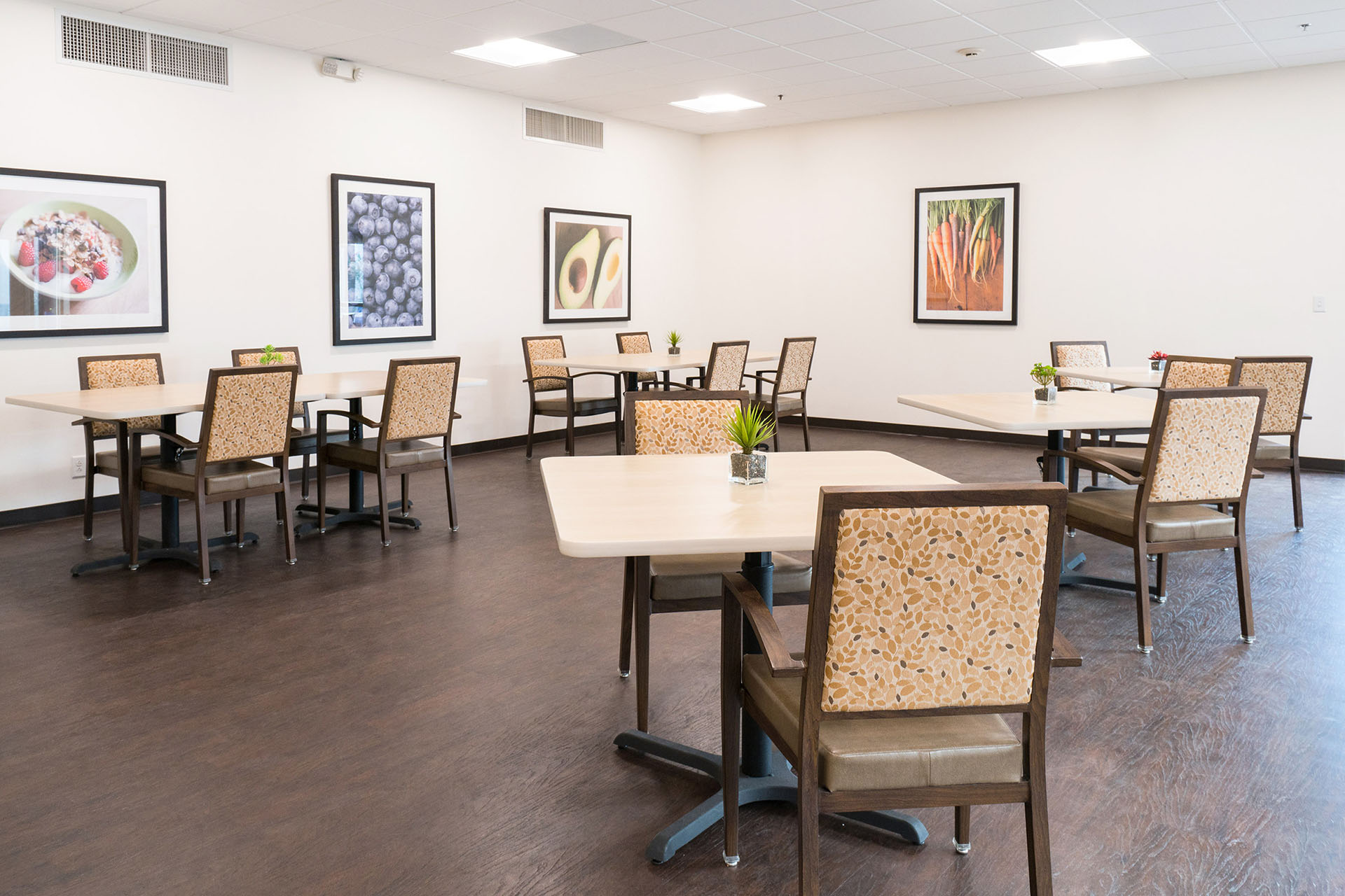 A communal dining room decorated with paintings