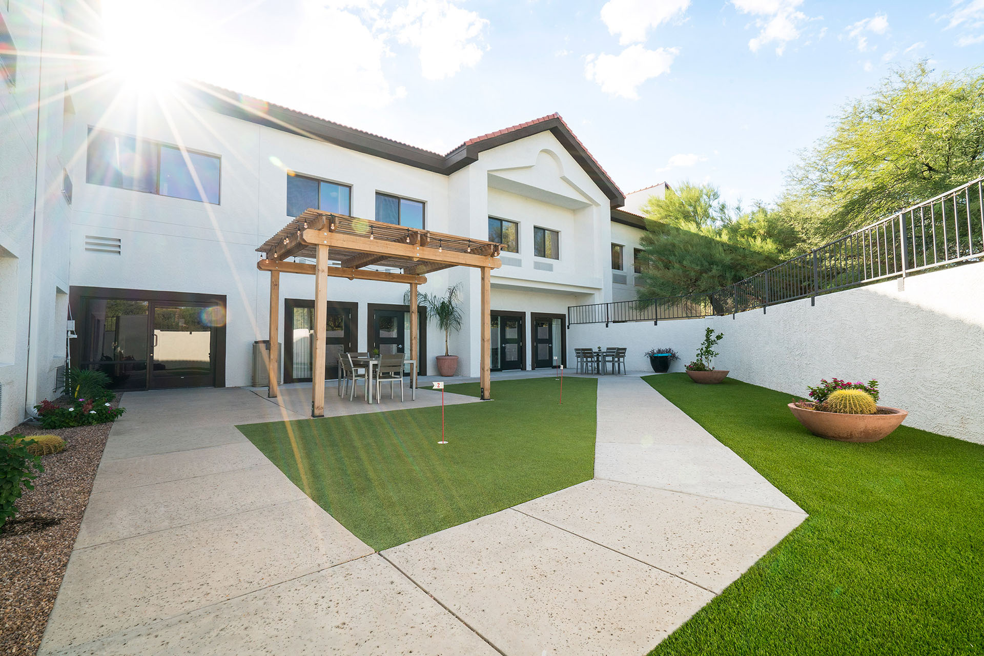 A green lawn and pergola