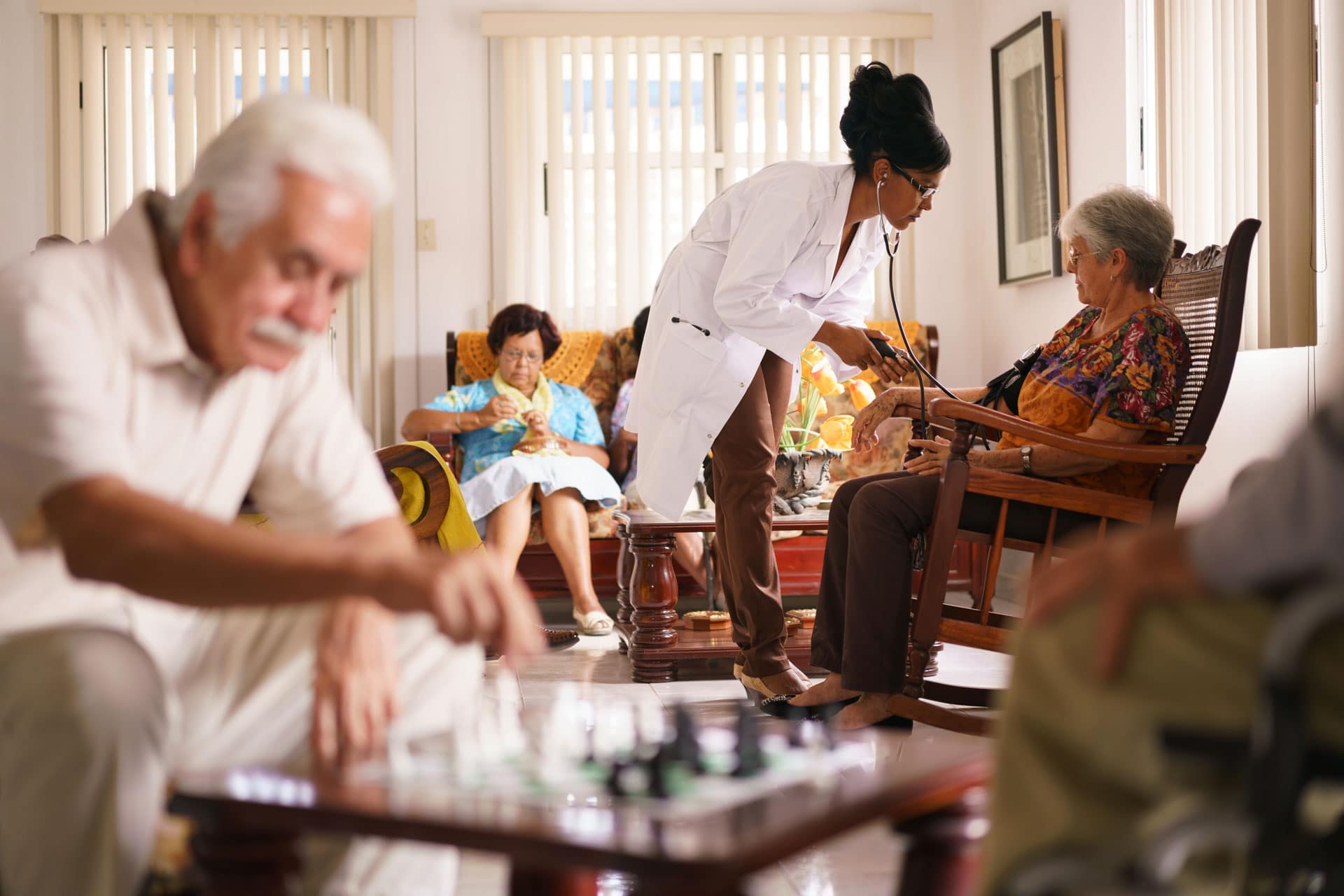 Doctor checking patients blood pressure