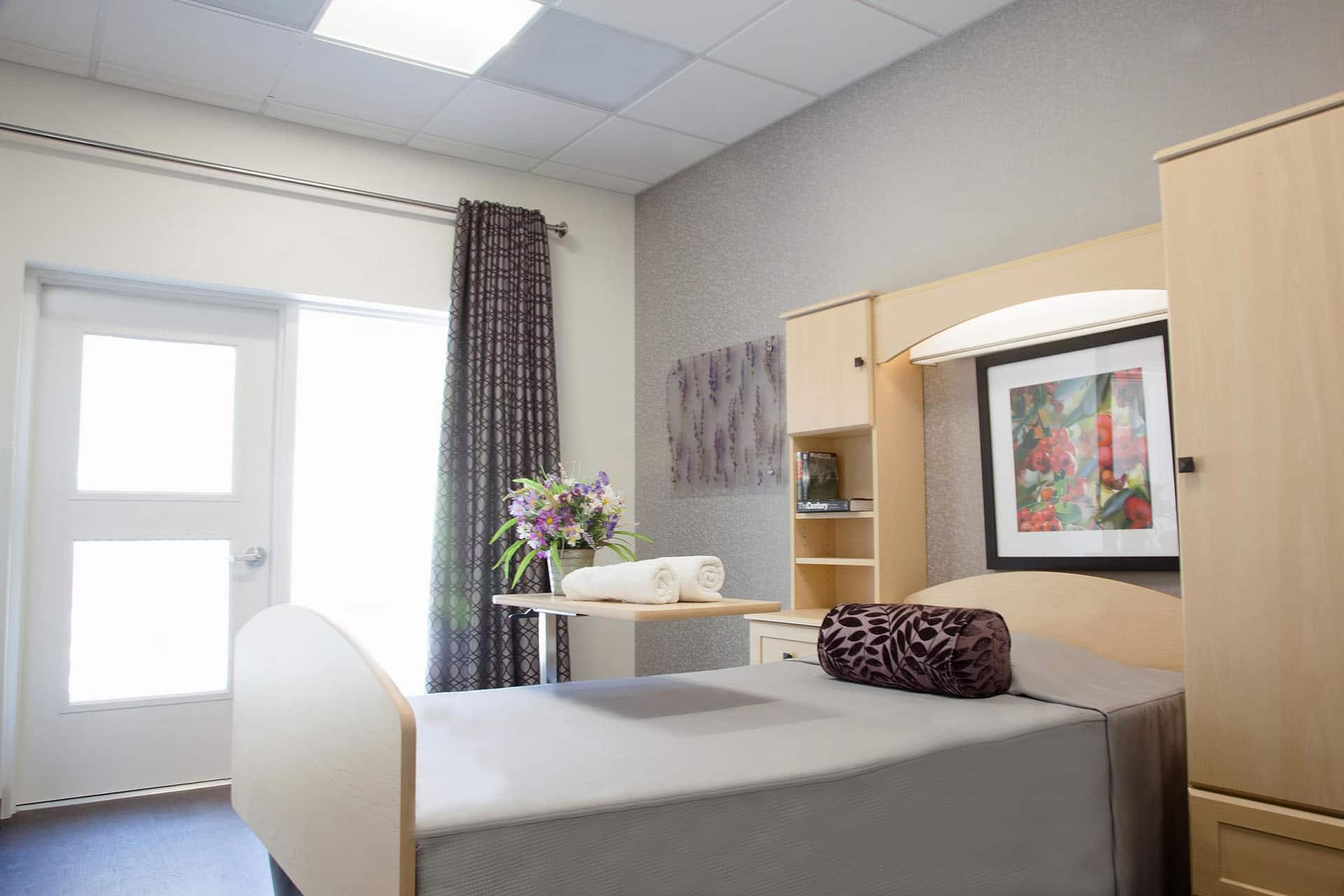 A twin murphy bed in a gray room