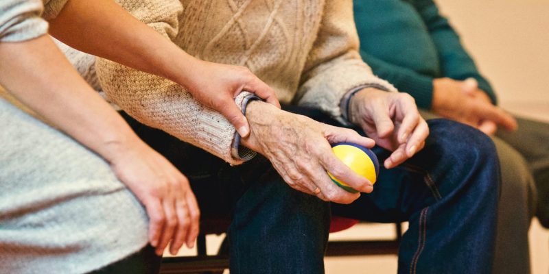 Skilled nurse helping patient with physical therapy