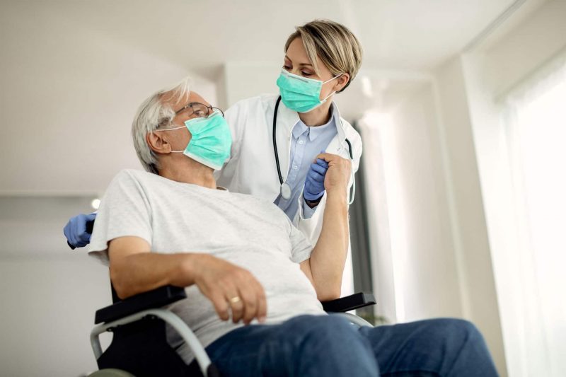 nurse pushing patient in wheelchair