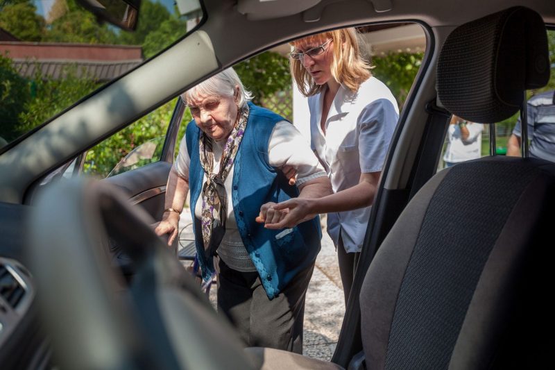 Cna Helping Patient Into Car