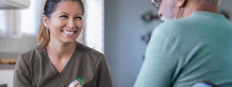 Skilled nurse helping patient with medication