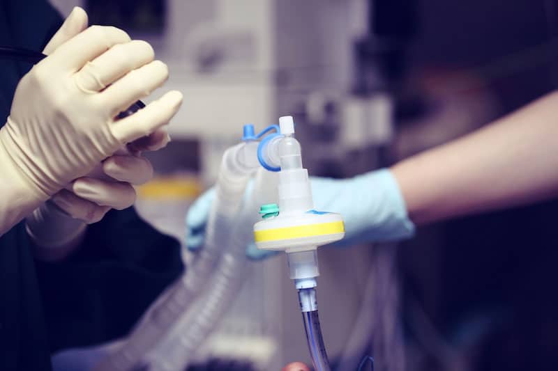 Skilled Nurses Caring For Patient With Tracheostomy Tube