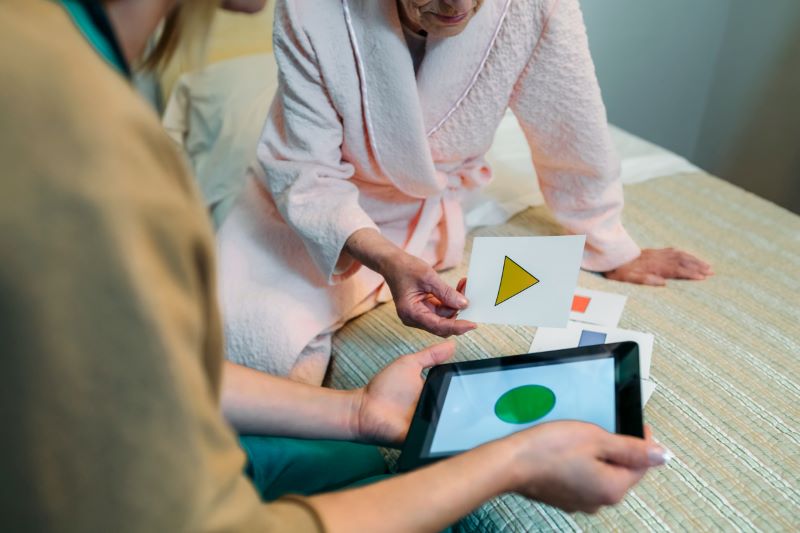 Nurse trying visual cues game with elderly dementia patient