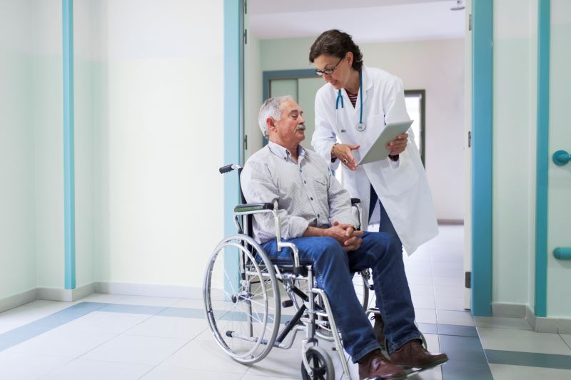 elder man with his doctor getting discharged from hospital