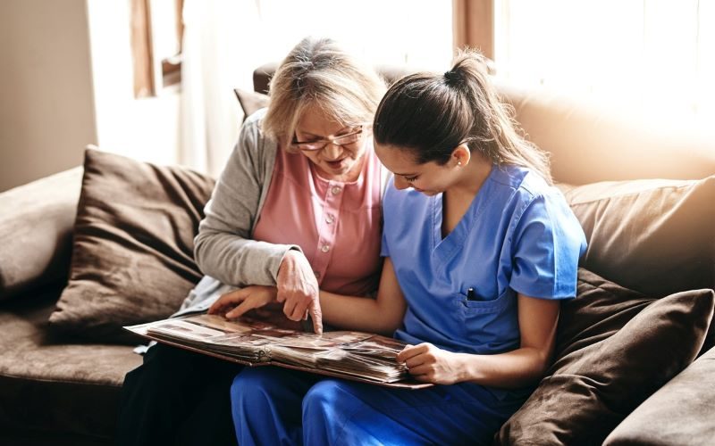 female nurse focusing on triggering memories with her senior patient