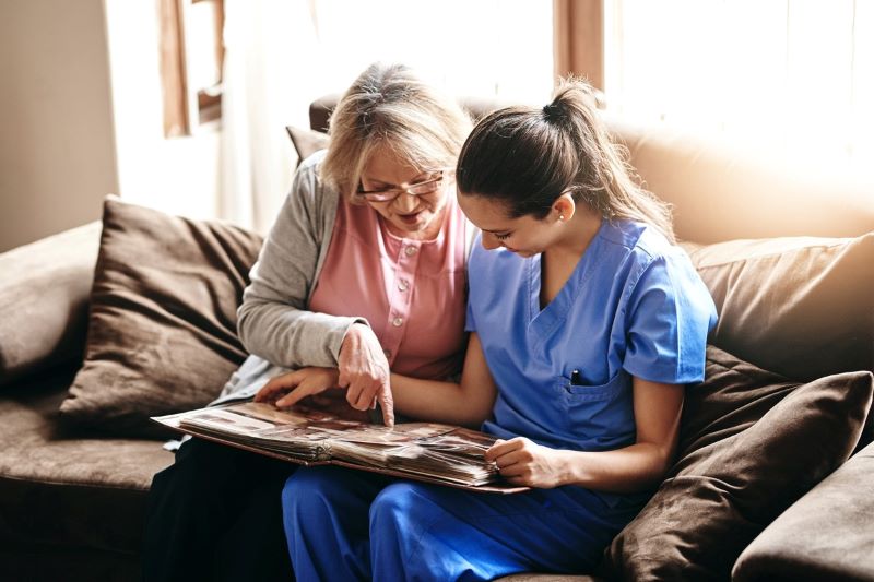 female nurse focusing on triggering memories with her senior patient