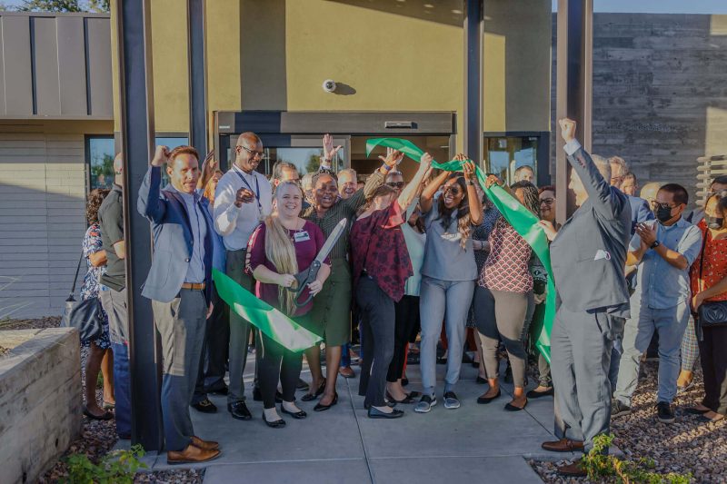 cheering after cutting the ribbon for reopening of Phoenix Haven Health