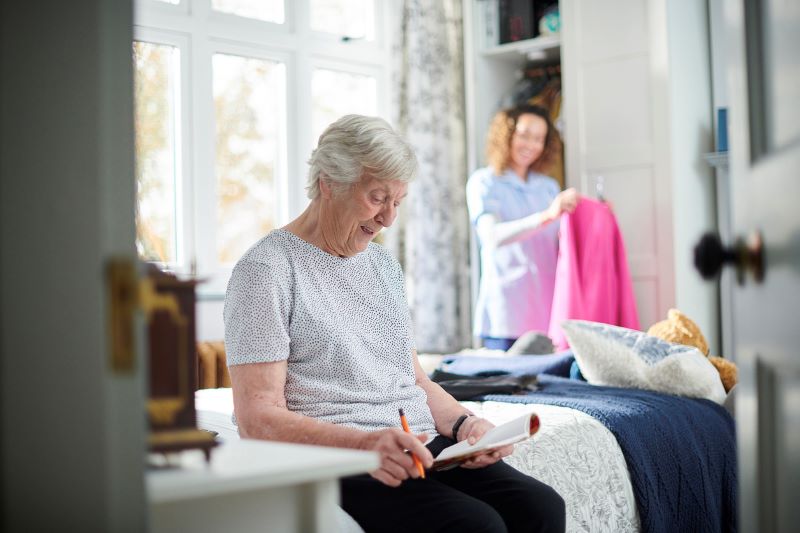 elderly woman doing cbt therapy by writing in a journal