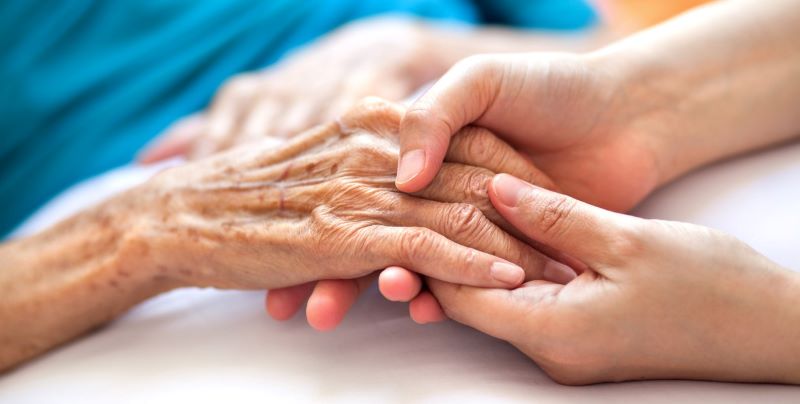 Caring Professionals Taking Care Of A Patient With Dementia