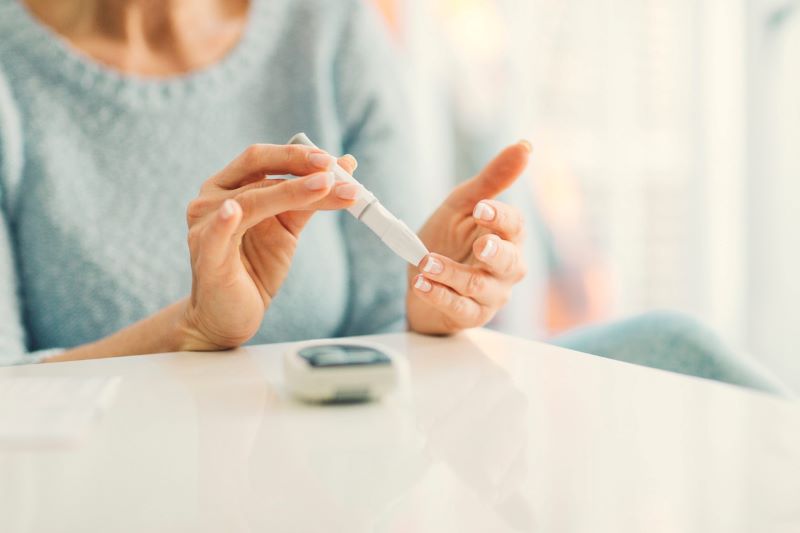 Woman Checking Her Blood Sugar Test Because Of Diabetes