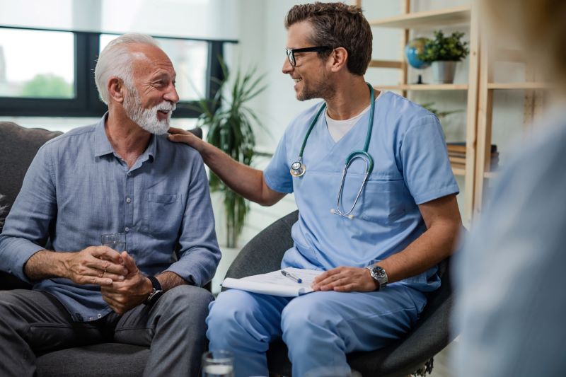 elder man talking with doctor before getting infusion therapy