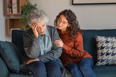Woman comforting older distraught woman