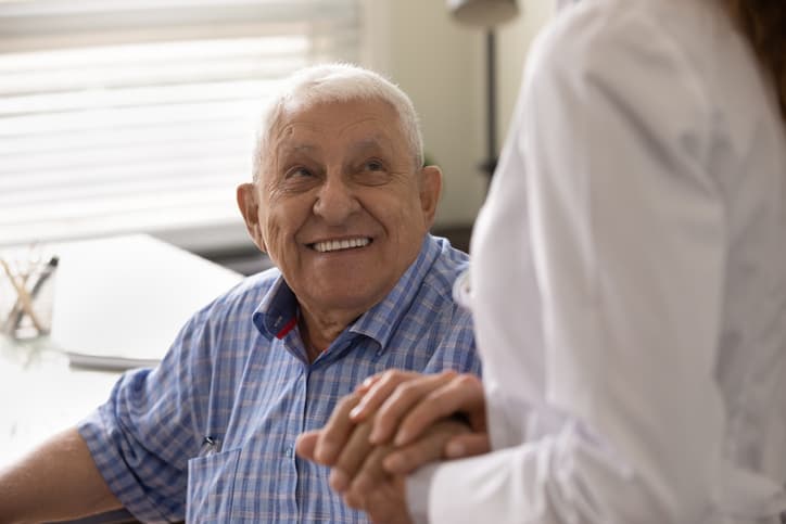 Old man smiling at care worker