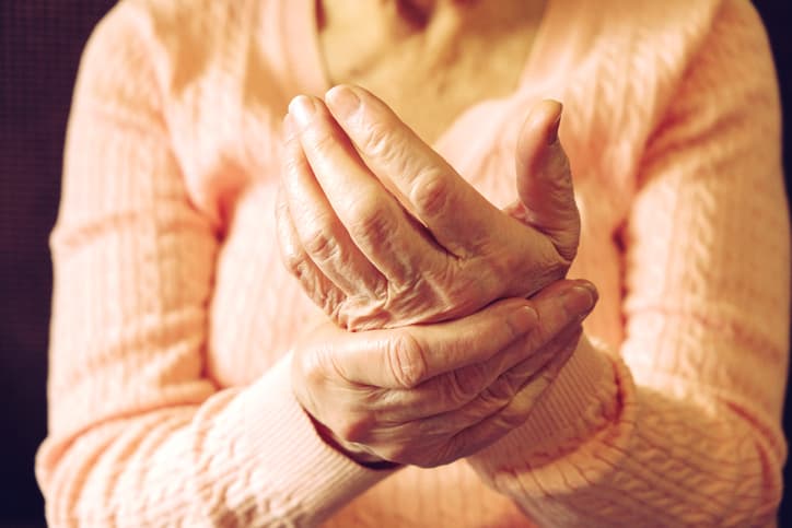 Elderly woman with joint pain in her hands