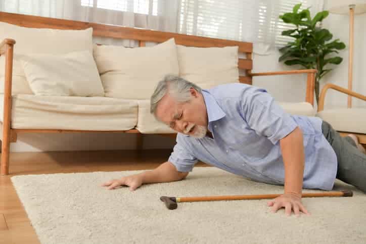 Elderly man who has fallen down in his living room