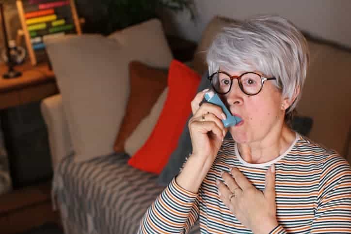 Older woman using inhaler 