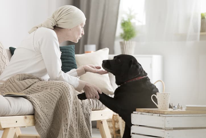 Cancer patient petting her dog