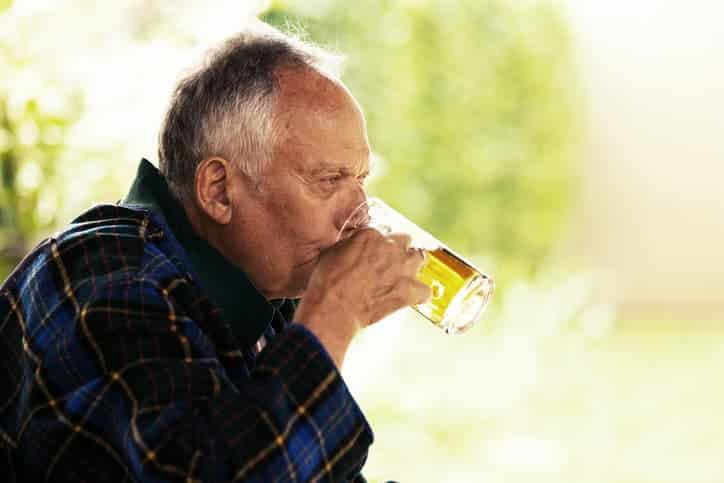 older man drinking beer