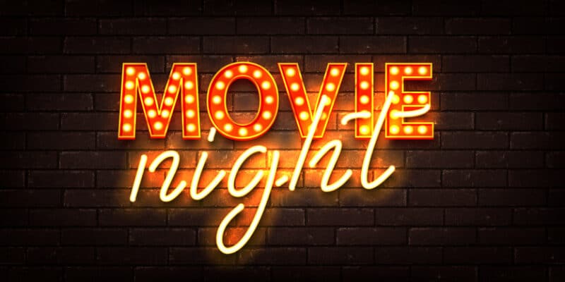 An orange neon sign that says "Movie Night"