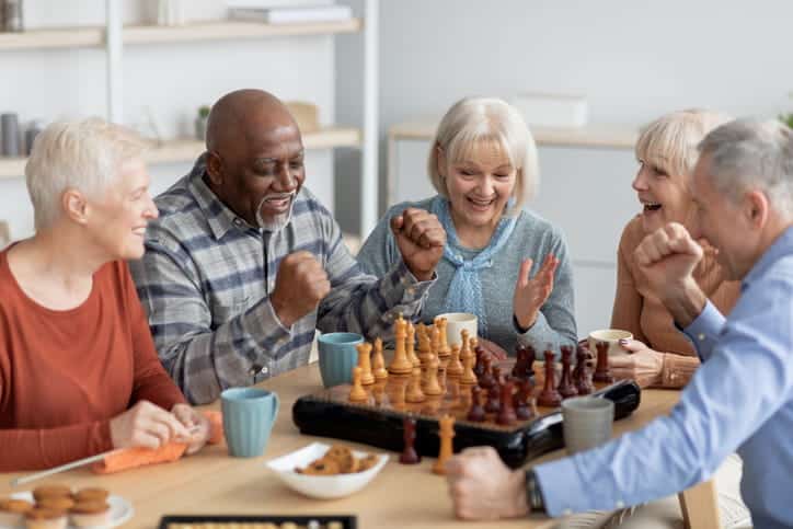 a group of seniors playing a board game.