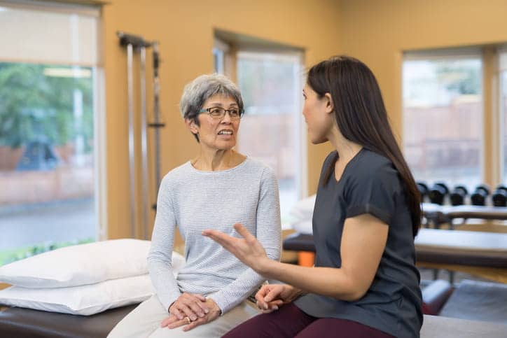 A speech therapist works with her adult patient