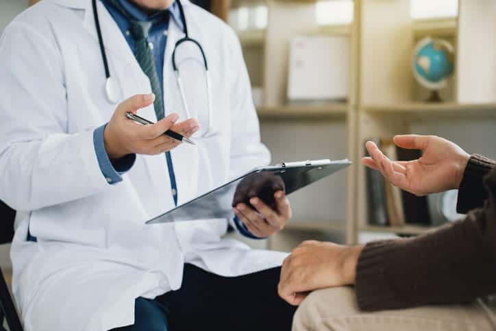 A patient speaking to their doctor about their colorectal cancer screening results.