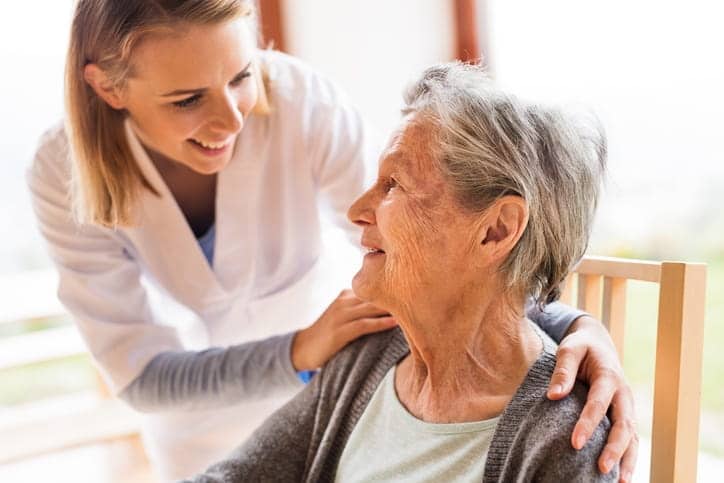 An aid caring for an elderly woman.