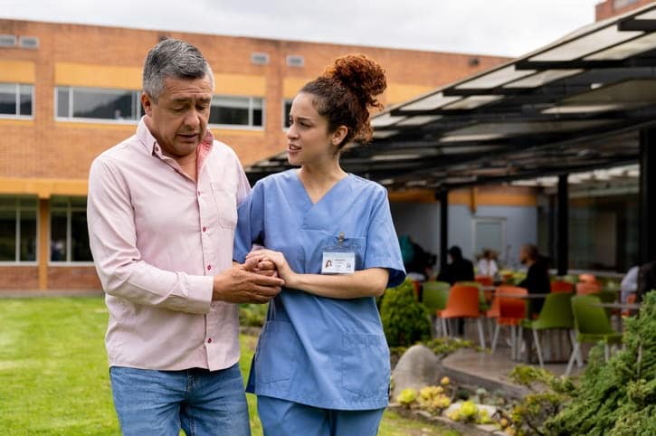 A nurse assisting a patient at an assisted living facility. 