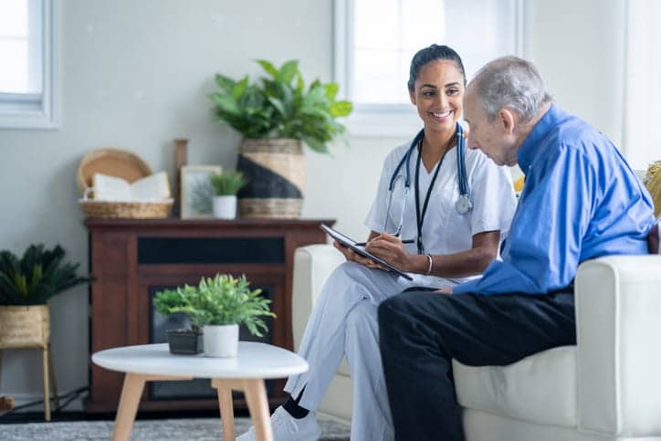 A nurse assisting a patient in an assisted living facility. 