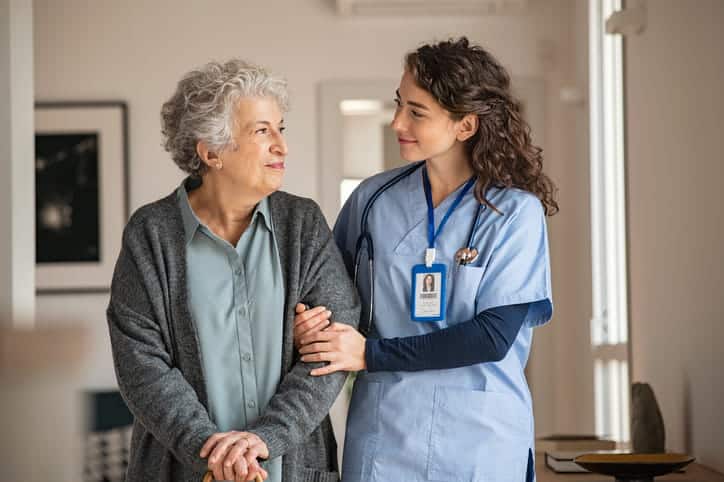 A nurse assisting an elderly patient at a skilled nursing facility. 