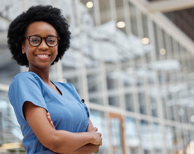 A nurse smiling for the camera. 