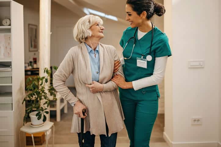 A nurse assisting an elderly patient at a skilled nursing facility. 