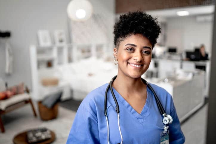 A nurse in scrubs at a skilled nursing center. 