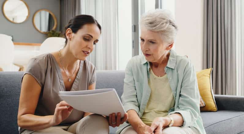A woman is going over assisted living options with her elderly mother.