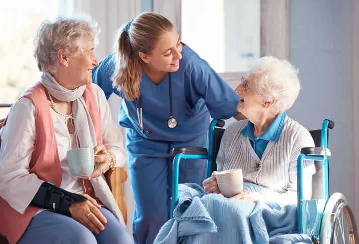Nurse talking to woman older woman in wheelchair