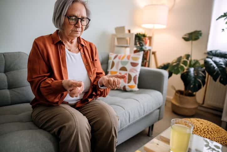 An elderly woman experiencing wrist pain due to arthritis. 