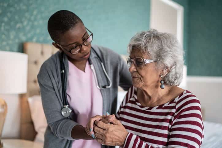 An Aid Helping An Alzheimer'S Patient At A Skilled Nursing Facility. 