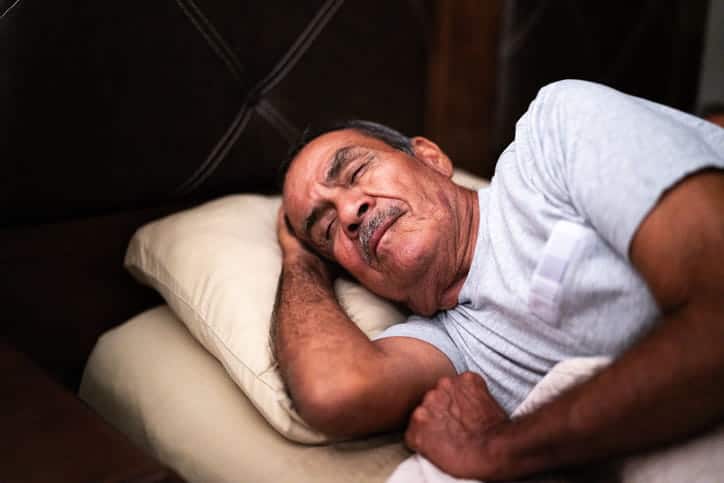 An Elderly Man Sleeping In Bed.