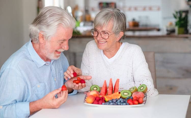 Two Seniors Eating Nutritional Foods Together. 