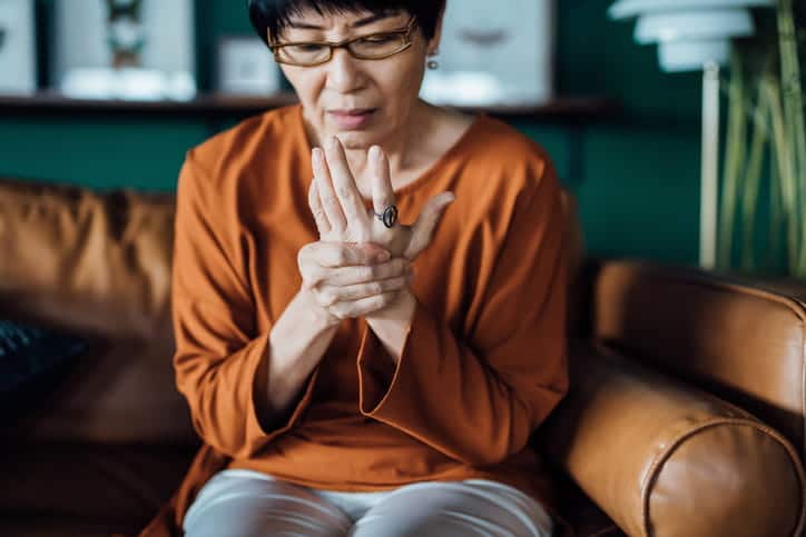 An Elderly Woman Rubbing Her Hand Because Of Joint Pain.