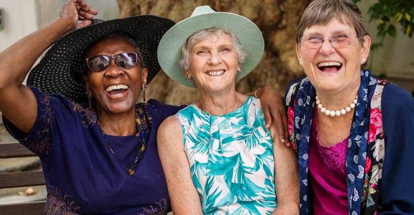 Three Women Smiling Together.