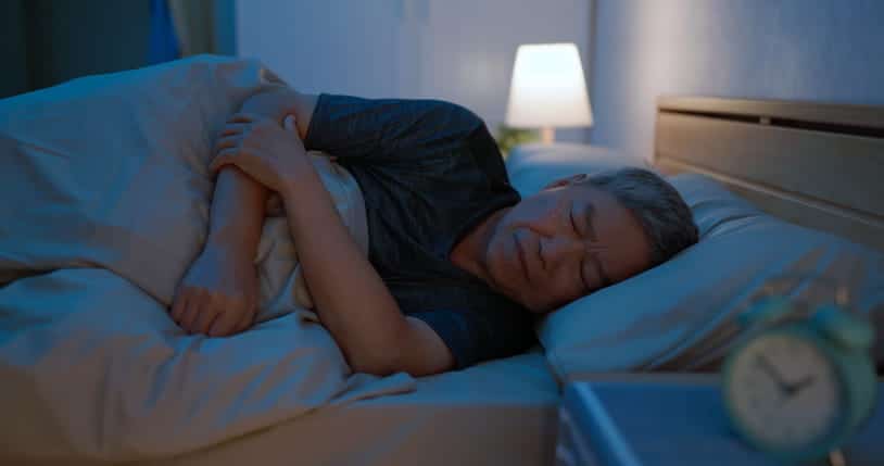 A Senior Sleeping In Bed.