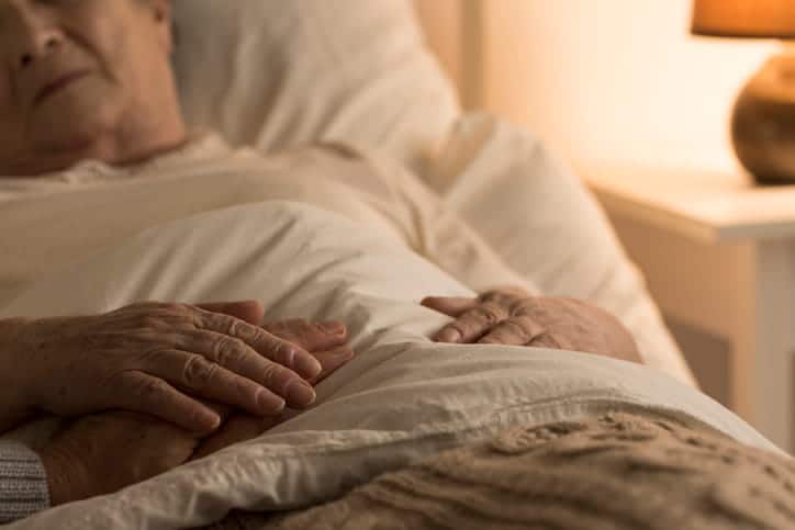 A Senior Lying In Bed.