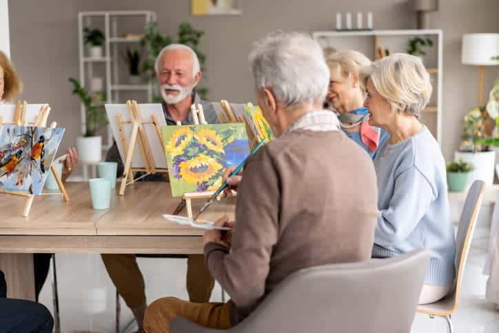 A Group Of Seniors Taking A Painting Class Together.