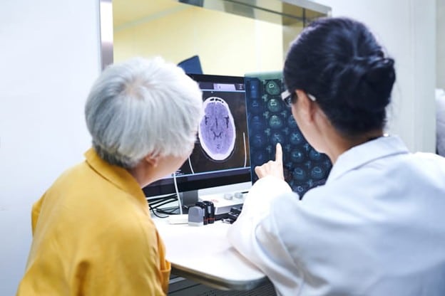 A Doctor Going Over Results Of A Brain Mri With A Patient.