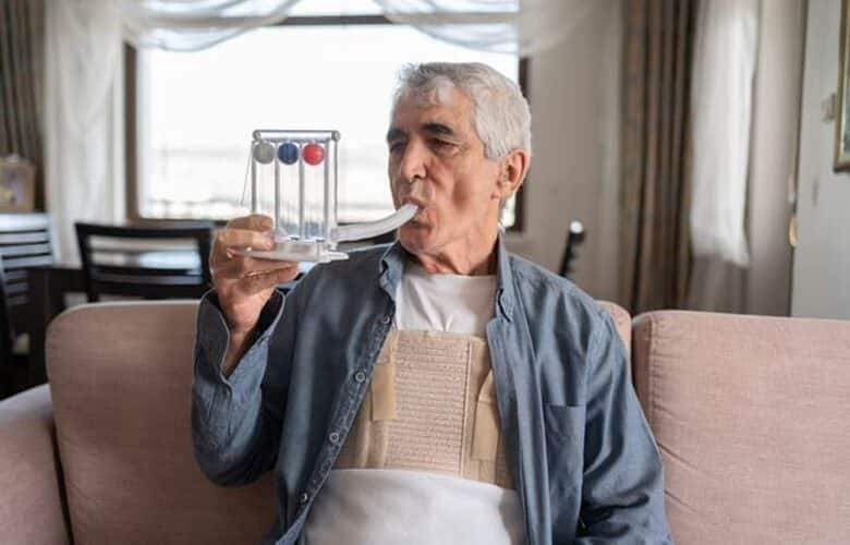 An Elderly Man Doing Breathing Exercises.