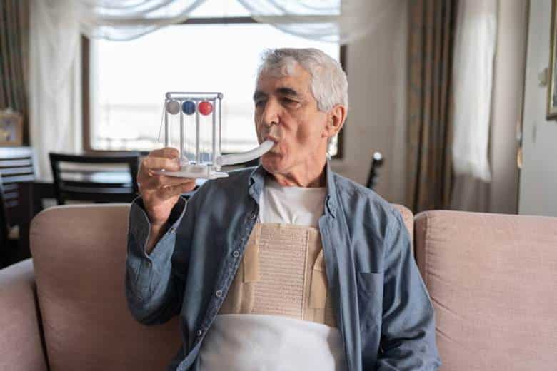 An Elderly Man Doing Breathing Exercises.